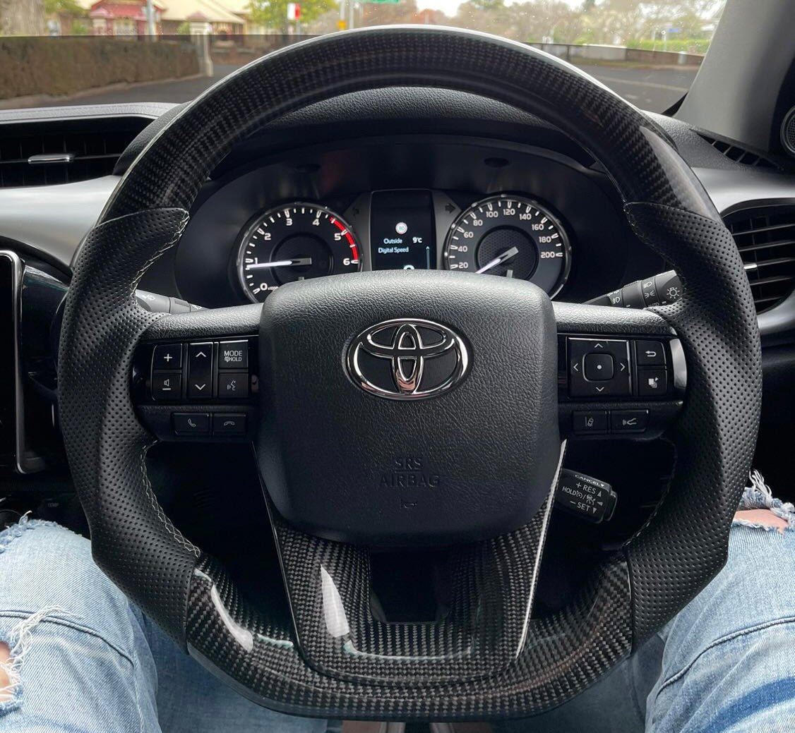 Premium Steering Wheel - Carbon Fiber / Perforated Leather suitable for use with Toyota Hilux N80 2015 - 2025 - Tech4tourers