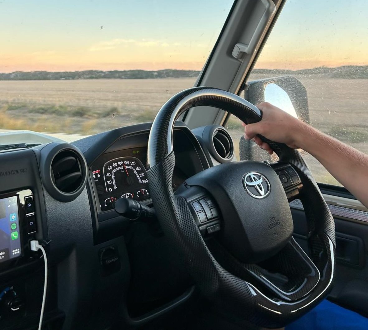 Premium Steering Wheel- Carbon Fiber / Perforated leather suitable for use with Toyota LandCruiser 70 series 2024-On