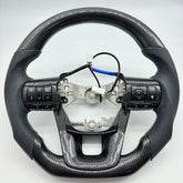 Premium Steering Wheel- Carbon Fiber / Perforated leather suitable for use with Toyota LandCruiser 70 series 2024-On