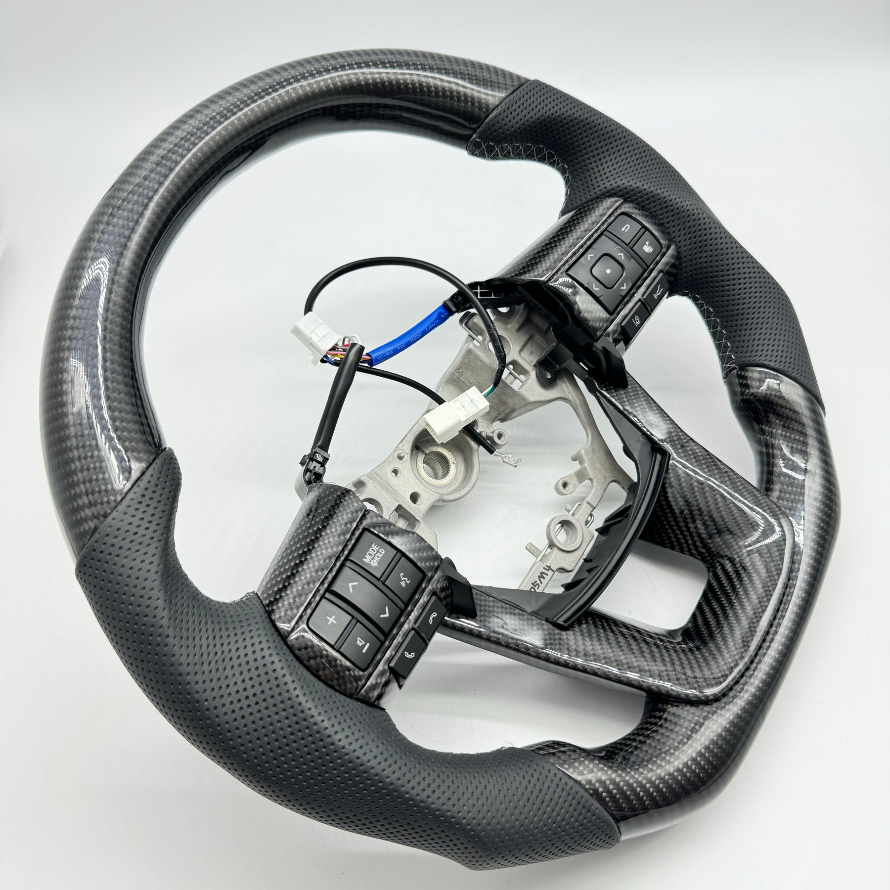 Premium Steering Wheel- Carbon Fiber / Perforated leather suitable for use with Toyota LandCruiser 70 series 2024-On
