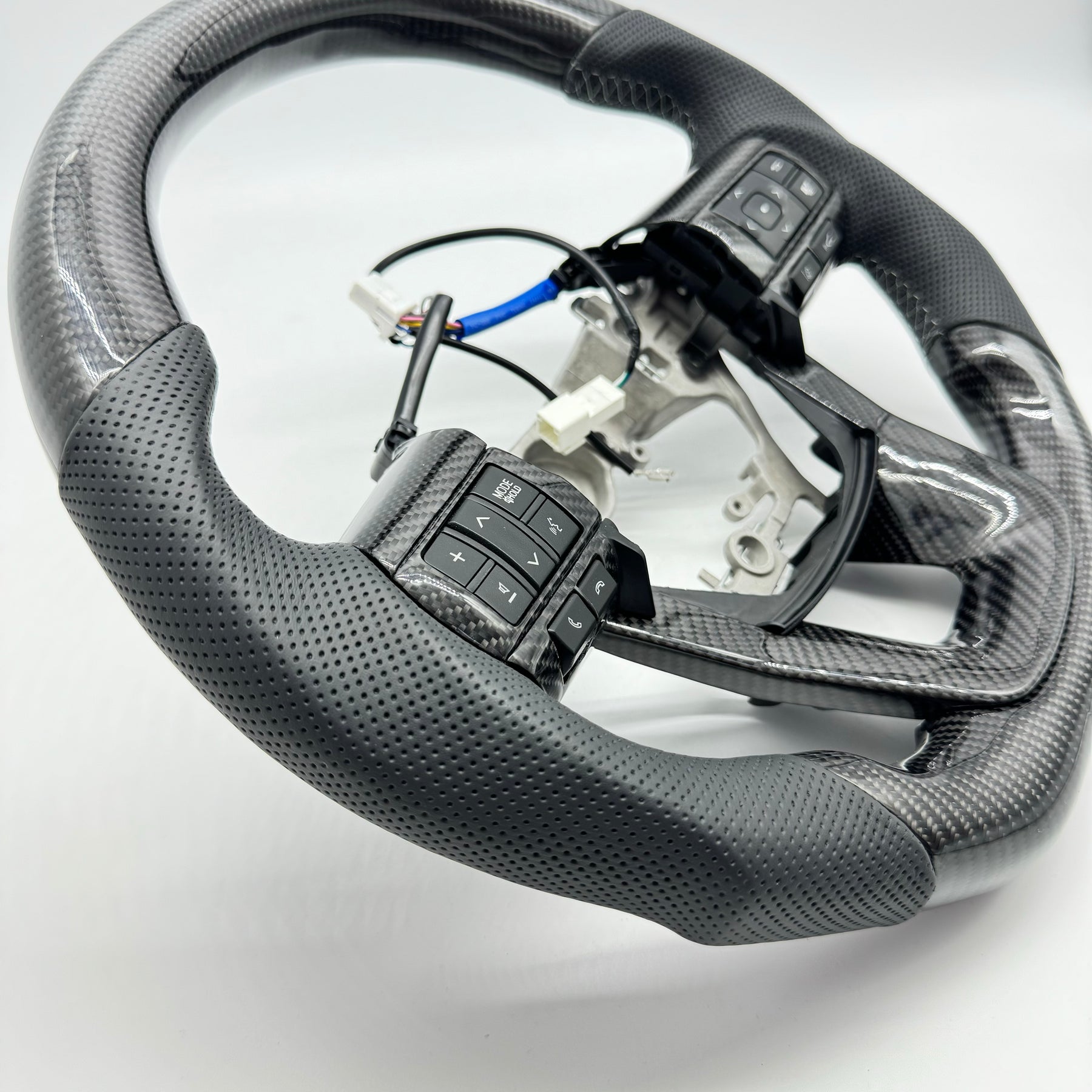 Premium Steering Wheel- Carbon Fiber / Perforated leather suitable for use with Toyota LandCruiser 70 series 2024-On