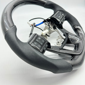 Premium Steering Wheel- Carbon Fiber / Perforated leather suitable for use with Toyota LandCruiser 70 series 2024-On