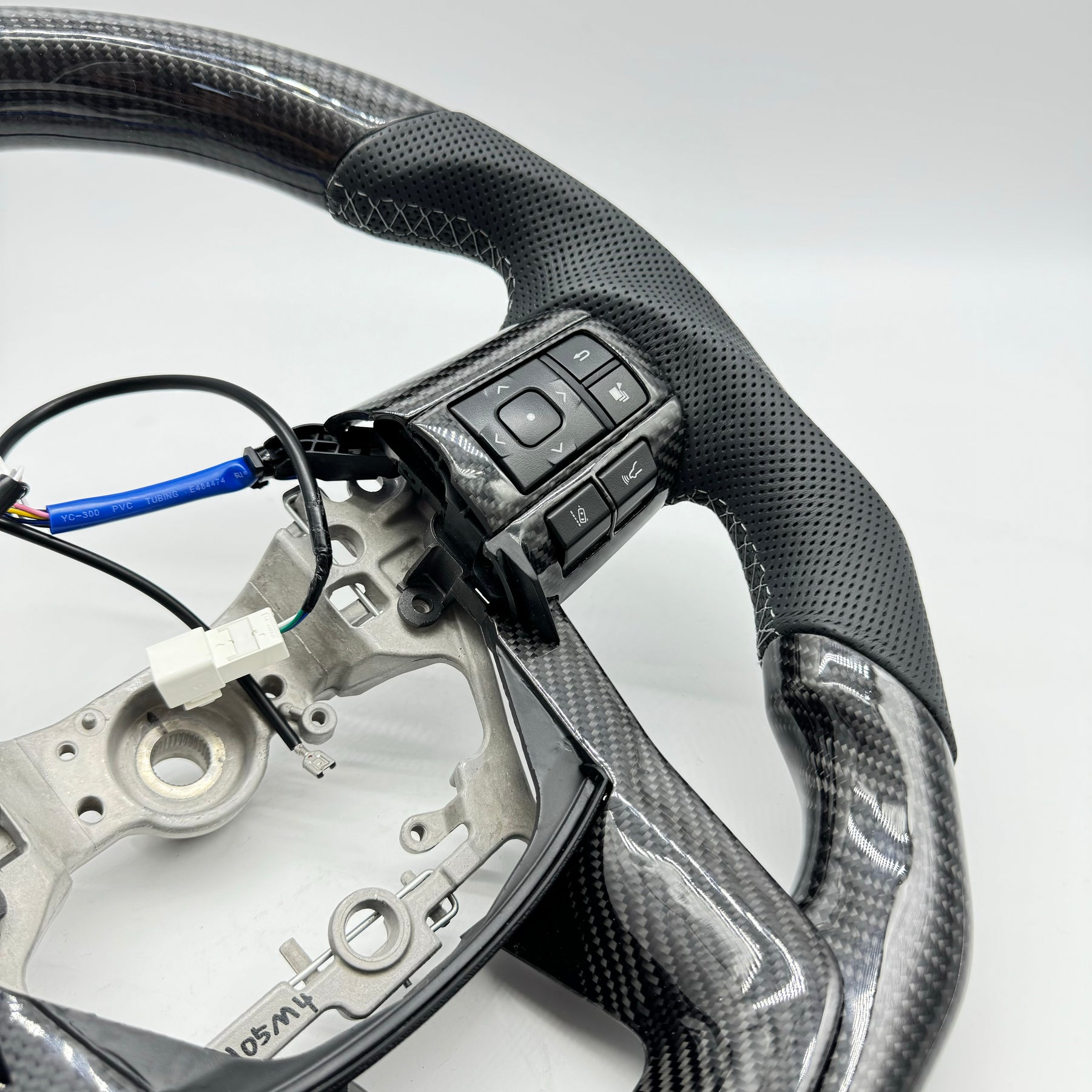 Premium Steering Wheel- Carbon Fiber / Perforated leather suitable for use with Toyota LandCruiser 70 series 2024-On
