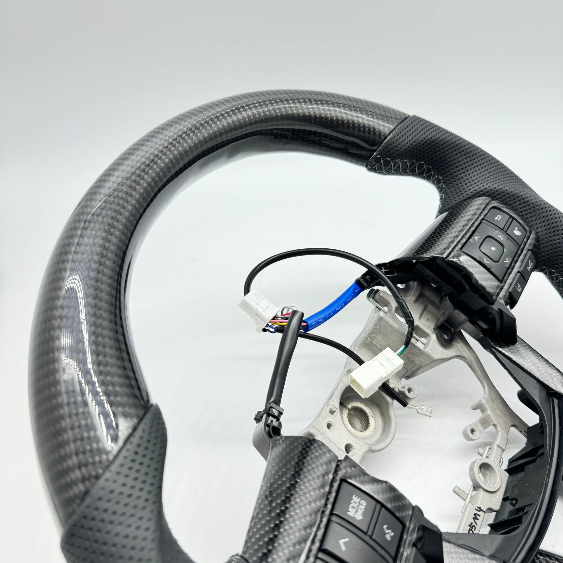 Premium Steering Wheel- Carbon Fiber / Perforated leather suitable for use with Toyota LandCruiser 70 series 2024-On